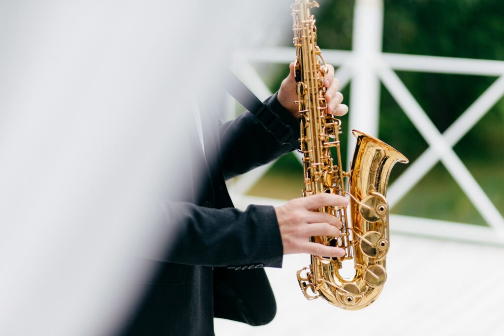 Crop musician playing saxophone