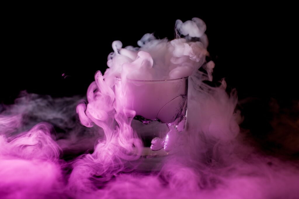Glass with smoke at dark background